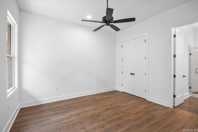 unfurnished bedroom with dark hardwood / wood-style flooring and ceiling fan