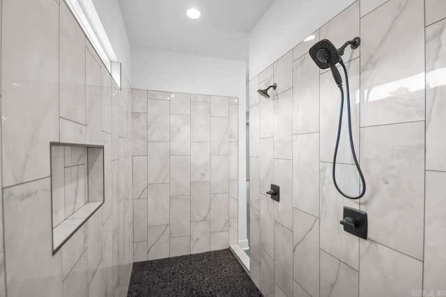 bathroom with a tile shower