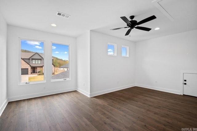 unfurnished room with dark wood-type flooring and ceiling fan