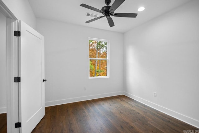 spare room featuring dark hardwood / wood-style floors and ceiling fan