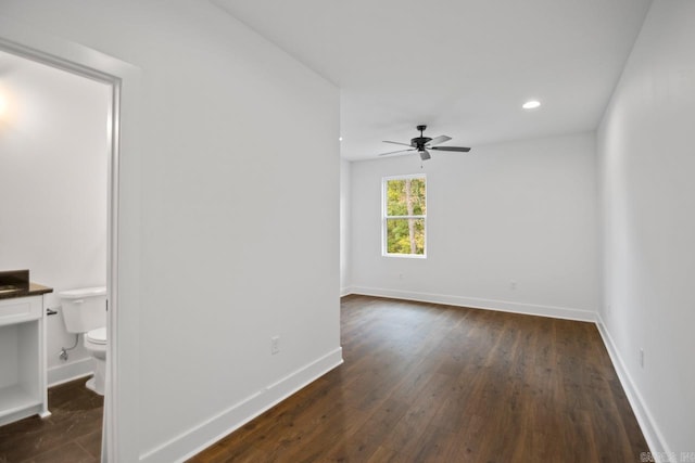 spare room featuring dark hardwood / wood-style floors and ceiling fan