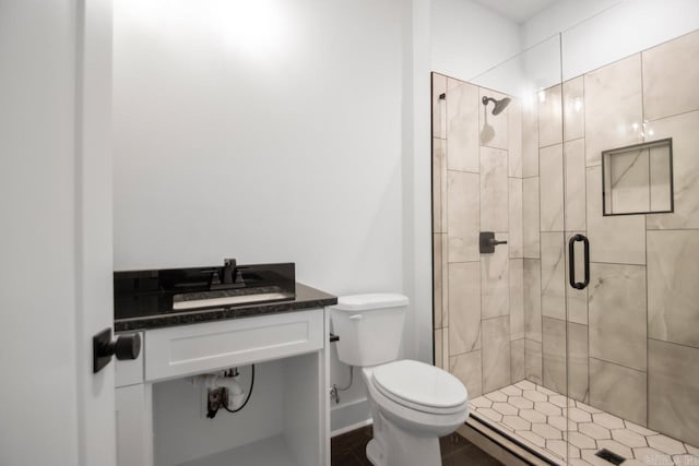 bathroom featuring toilet, an enclosed shower, and vanity