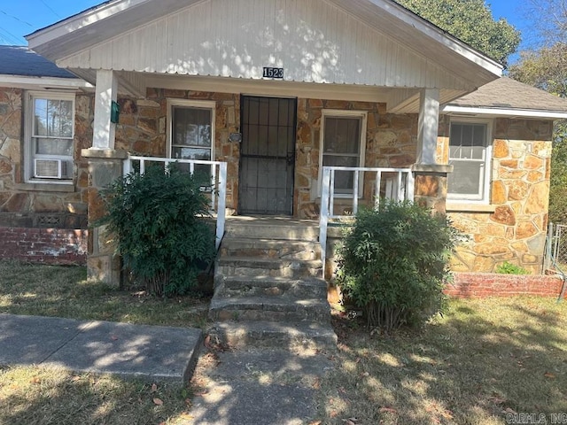 doorway to property with a porch and cooling unit