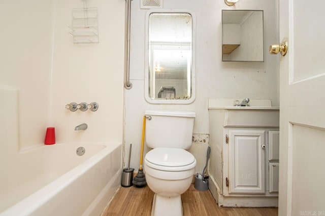 full bathroom featuring vanity,  shower combination, hardwood / wood-style flooring, and toilet