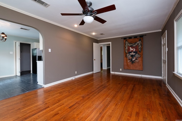 spare room with ornamental molding, dark hardwood / wood-style floors, and ceiling fan