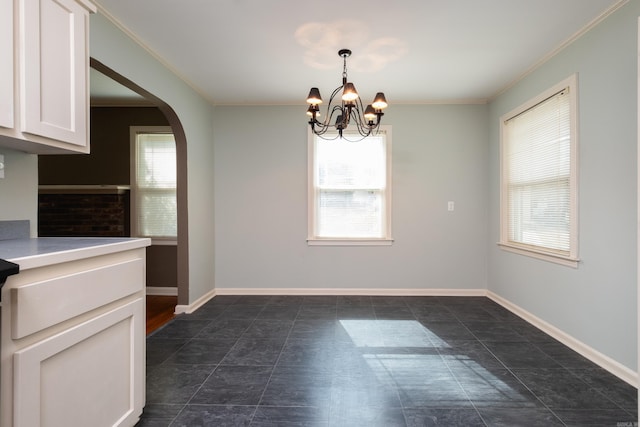 unfurnished dining area featuring ornamental molding and a notable chandelier