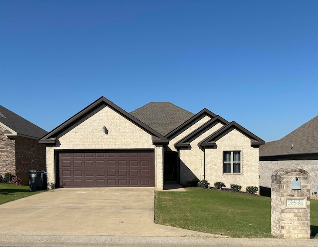 view of front of home with a front lawn and a garage