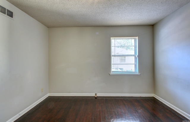 unfurnished room with a textured ceiling and dark wood-type flooring