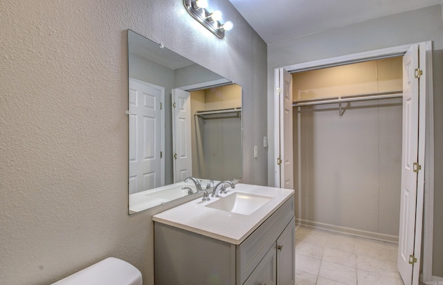 bathroom featuring toilet and vanity