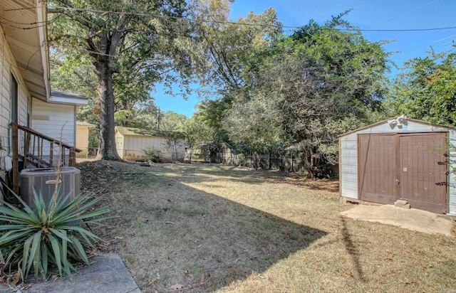 view of yard with a storage unit and cooling unit