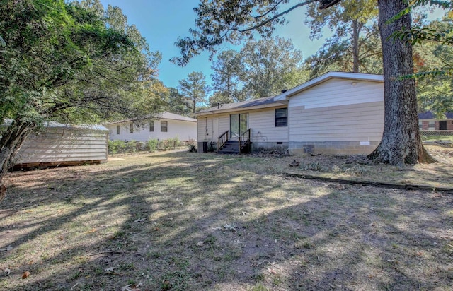 back of property featuring a lawn