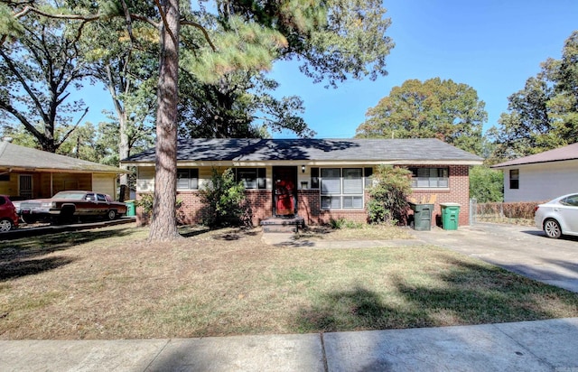 ranch-style home featuring a front yard