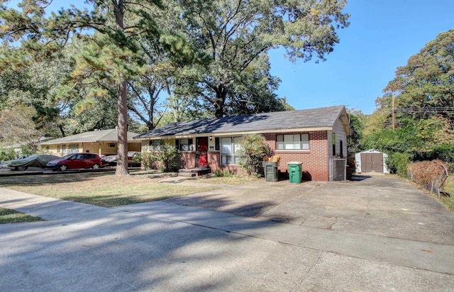 ranch-style home featuring a storage shed