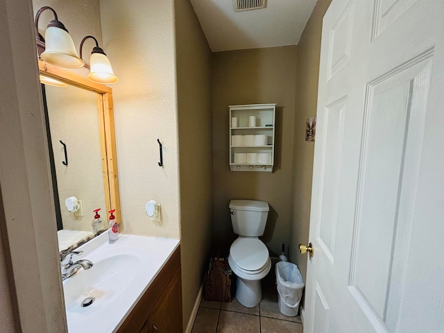 bathroom with vanity, toilet, and tile patterned flooring