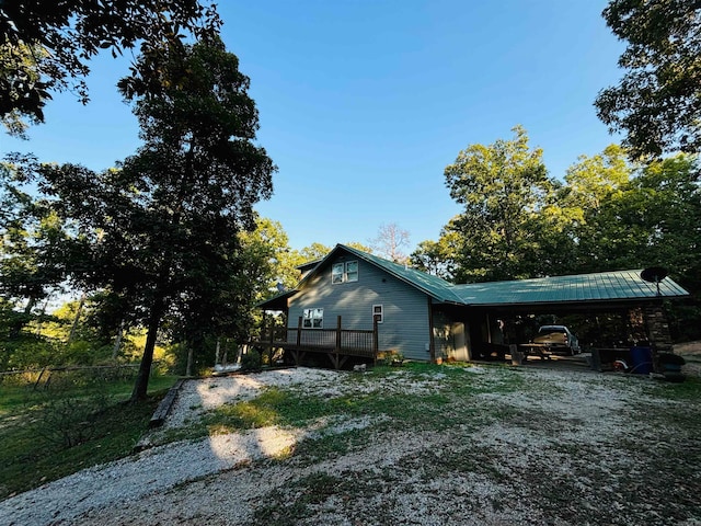 view of home's exterior with a wooden deck