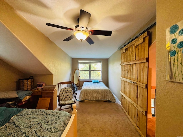 carpeted bedroom with vaulted ceiling and ceiling fan