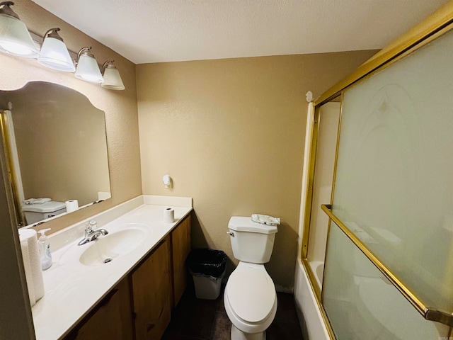 full bathroom with vanity, enclosed tub / shower combo, a textured ceiling, and toilet