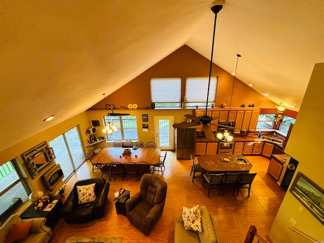 living room with high vaulted ceiling and ceiling fan