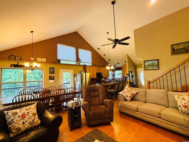 living room featuring hardwood / wood-style flooring, high vaulted ceiling, and ceiling fan with notable chandelier