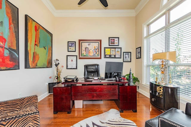 office area with ornamental molding, wood-type flooring, and ceiling fan