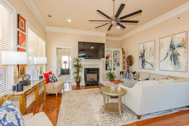 living room featuring ornamental molding, hardwood / wood-style floors, and a healthy amount of sunlight