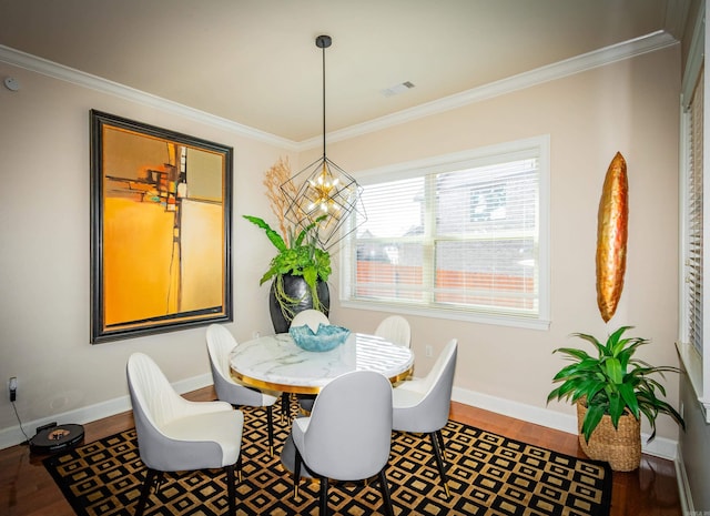 dining room with crown molding, a notable chandelier, and wood-type flooring