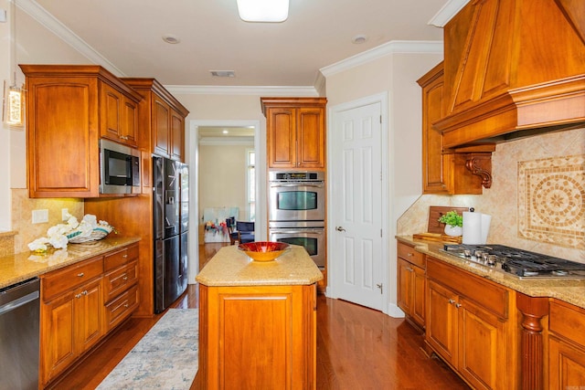 kitchen with appliances with stainless steel finishes, backsplash, a center island, custom exhaust hood, and dark wood-type flooring