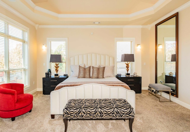 bedroom with a raised ceiling, ornamental molding, and light colored carpet