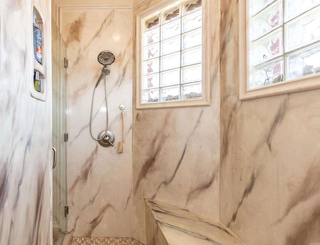 bathroom featuring a shower with shower door