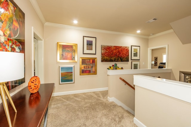 corridor with ornamental molding and light colored carpet