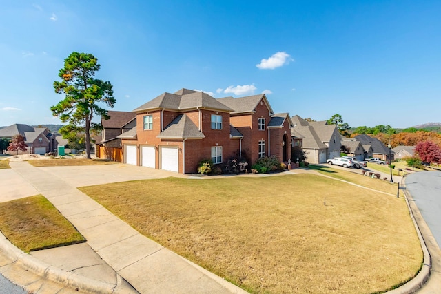 view of front of home featuring a front lawn and a garage