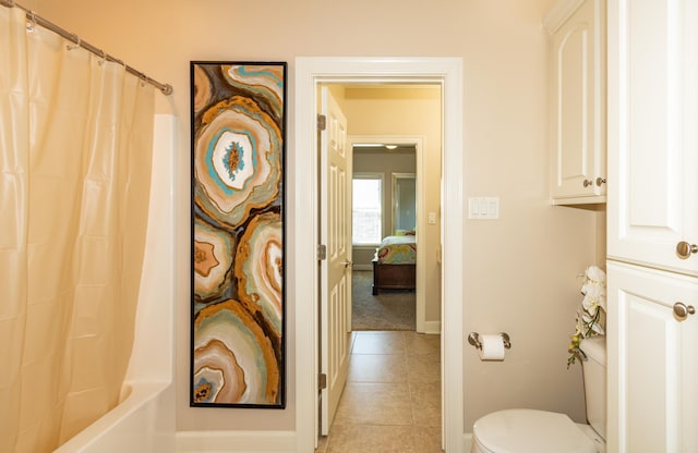 bathroom featuring shower / bath combo, toilet, and tile patterned flooring