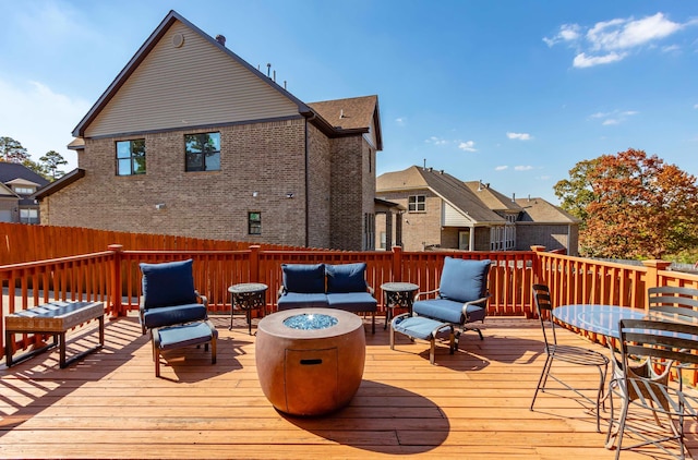 wooden terrace featuring an outdoor fire pit