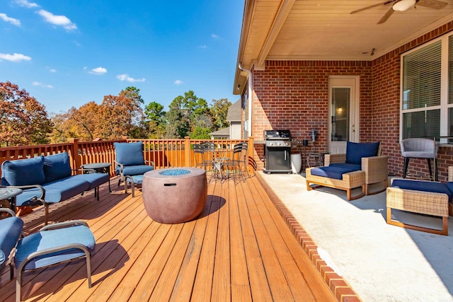 wooden terrace featuring an outdoor living space, grilling area, and ceiling fan