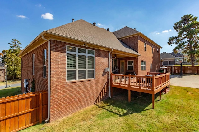 back of house featuring a patio, a deck, and a lawn