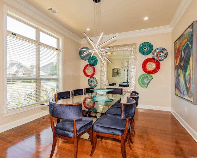 dining room with crown molding, wood-type flooring, and a wealth of natural light