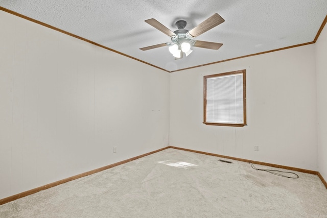 spare room with crown molding, a textured ceiling, carpet flooring, and ceiling fan