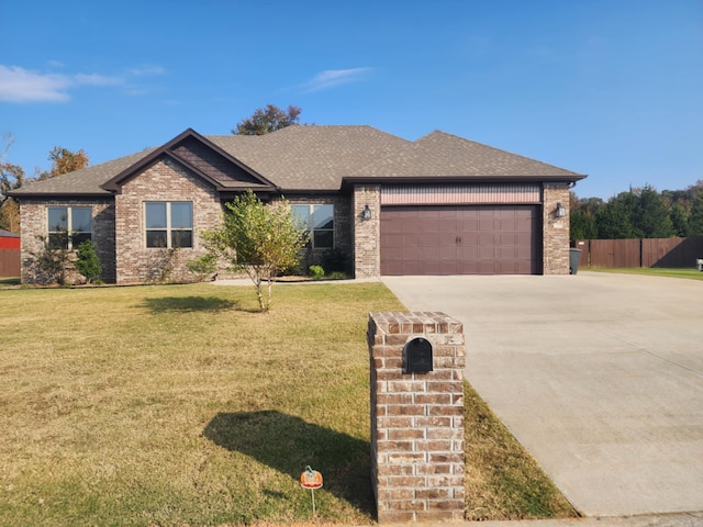 view of front of house featuring a garage and a front lawn