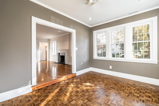 unfurnished living room with ornamental molding and dark parquet flooring