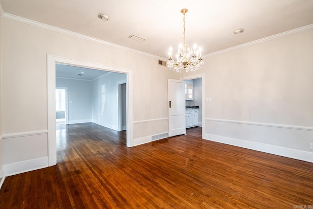 unfurnished dining area with ornamental molding, dark wood-type flooring, and an inviting chandelier