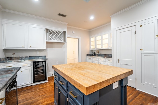 kitchen with dark wood-type flooring, wine cooler, a center island, blue cabinetry, and white cabinets