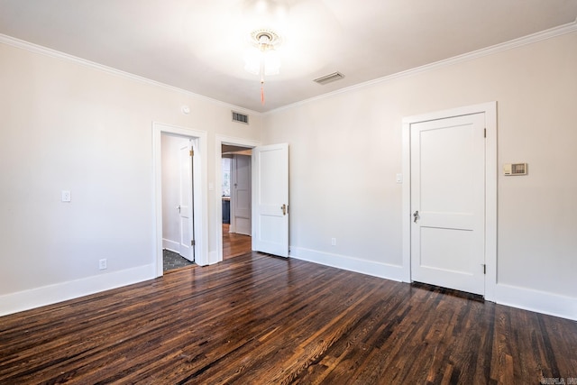 spare room featuring ornamental molding, dark wood-type flooring, and ceiling fan