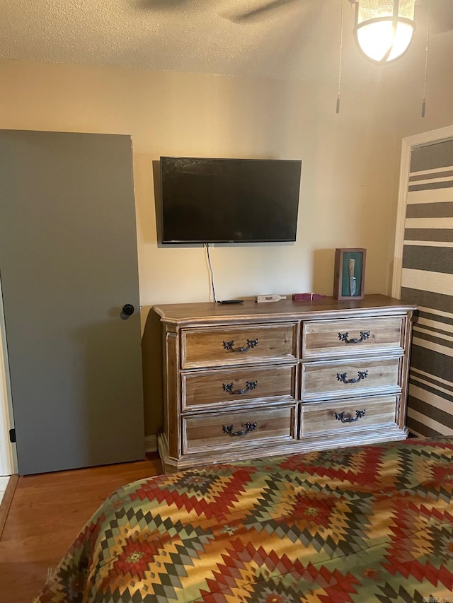 bedroom featuring light hardwood / wood-style flooring and a textured ceiling