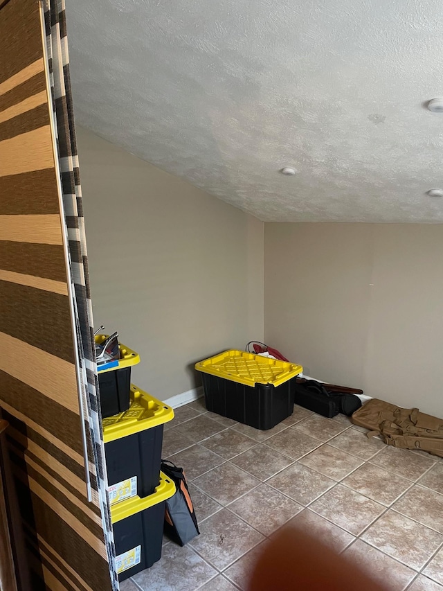 tiled bedroom featuring a textured ceiling