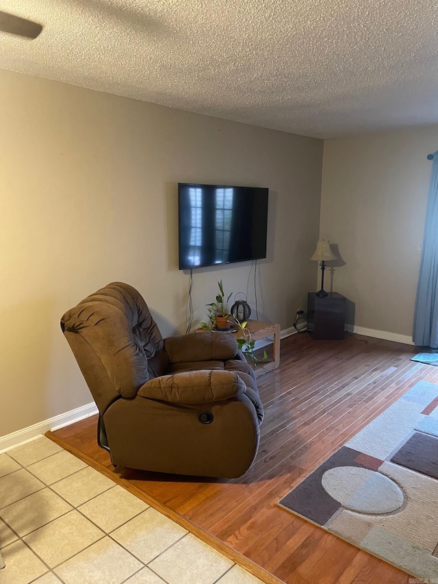 living room featuring hardwood / wood-style floors and a textured ceiling