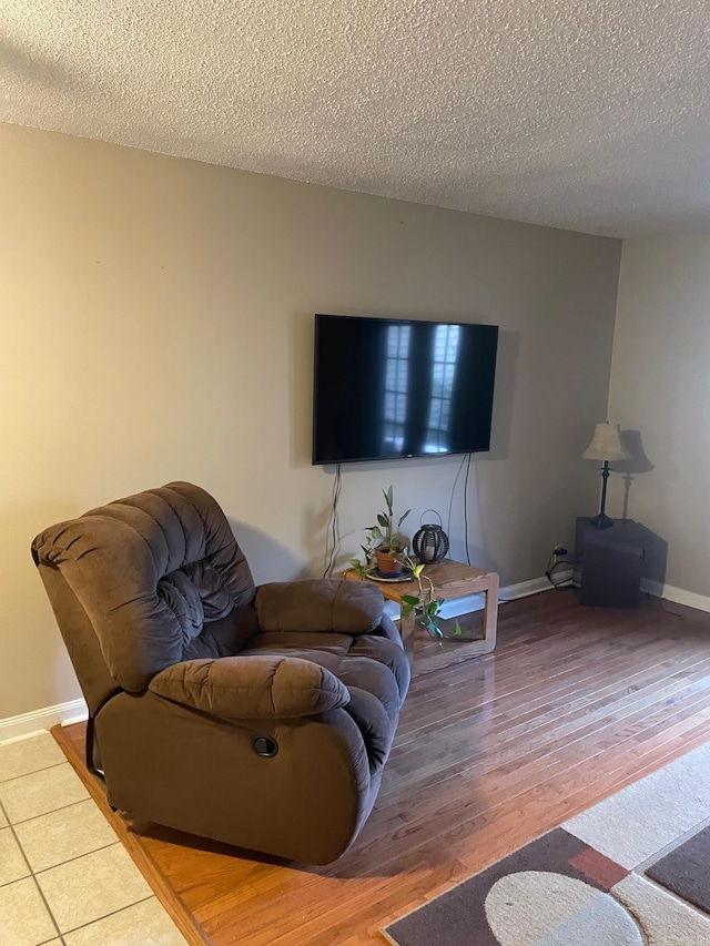 living room with a textured ceiling and hardwood / wood-style flooring