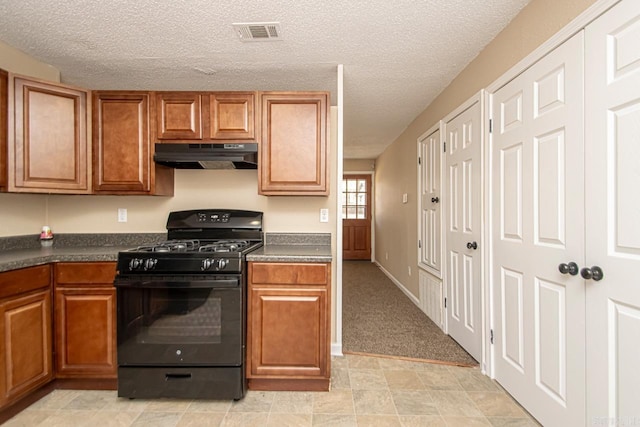 kitchen featuring light carpet, a textured ceiling, and black gas range oven