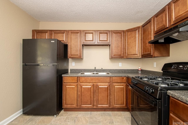 kitchen featuring a textured ceiling, black appliances, sink, and range hood