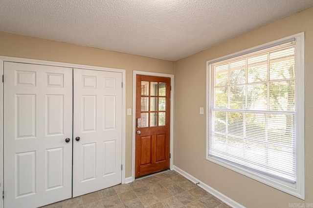 doorway featuring a textured ceiling