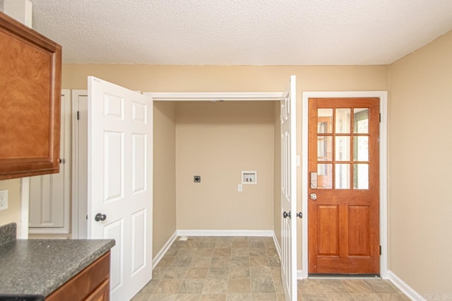 washroom featuring a textured ceiling, washer hookup, and hookup for an electric dryer